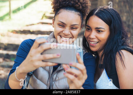 Happy young women friends taking selfie with smart phone Stock Photo