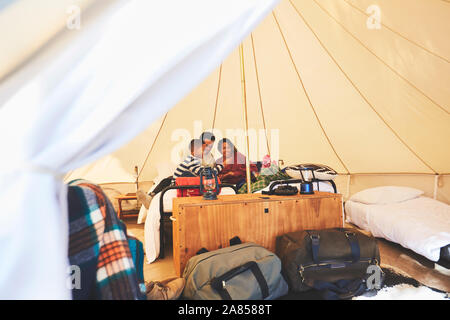 Family relaxing on bed inside camping yurt Stock Photo