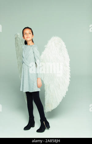 Portrait hopeful, ambitious girl wearing angel wings Stock Photo