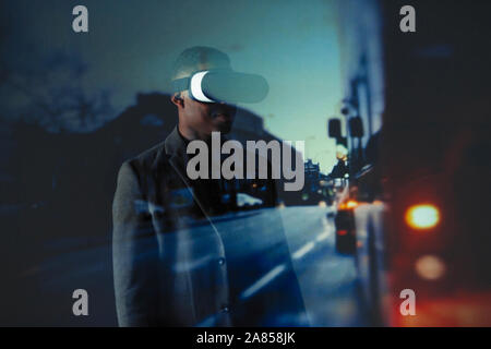 Double exposure businessman with virtual reality simulator glasses against city street Stock Photo