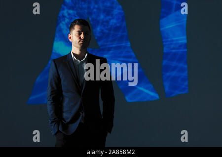 Double exposure businessman and AI text Stock Photo