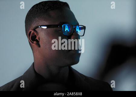 Double exposure businessman with reflection of AI text in eyeglasses Stock Photo