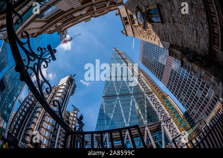 Looking up at 122 Leadenhall Street, also known as the Leadenhall Building or the Cheesegrater with the Lloyds building at Left Stock Photo