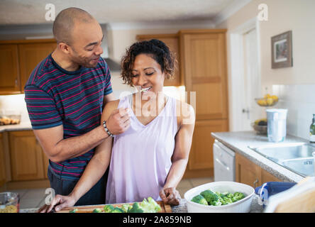 Happy couple cooking in kitchen Stock Photo