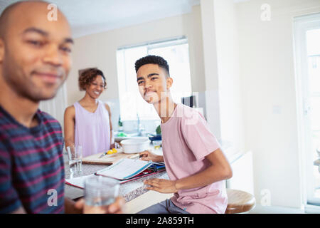Family cooking and doing homework in kitchen Stock Photo