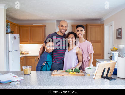 Portrait smiling family cooking in kitchen Stock Photo
