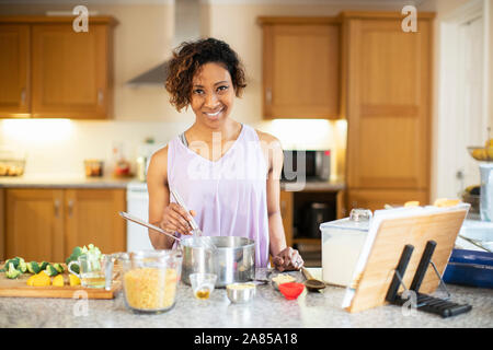 Portrait confident woman cooking in kitchen Stock Photo