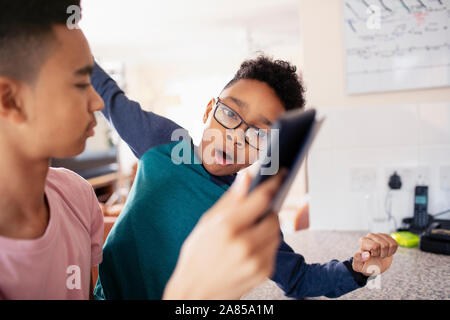 Brothers using digital tablet Stock Photo
