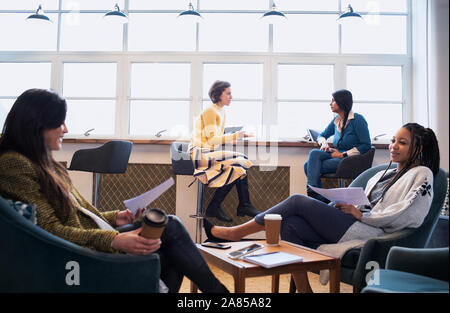 Businesswomen talking in office Stock Photo