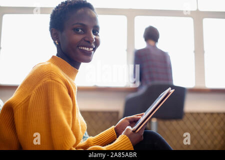 Portrait confident businesswoman using digital tablet Stock Photo