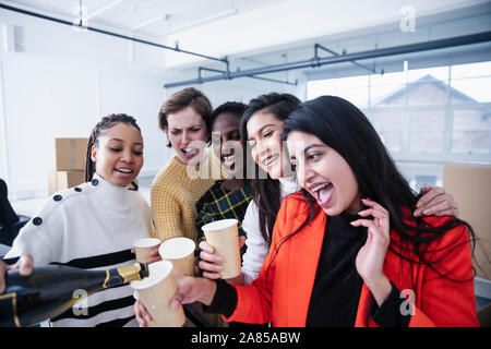 Businesswoman celebrating new office, drinking champagne Stock Photo