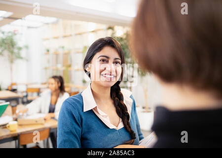 Smiling businesswomen talking in office Stock Photo