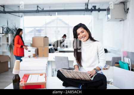Portrait smiling, confident businesswoman using laptop in new office Stock Photo