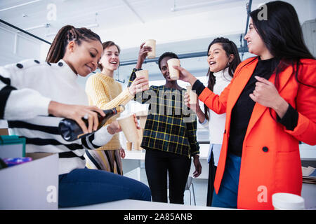Businesswomen celebrating new office with champagne Stock Photo