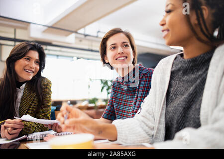 Businesswomen talking in conference room meeting Stock Photo