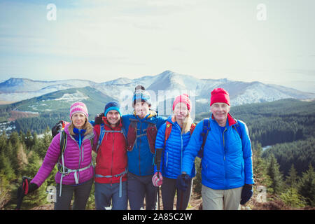 Portrait happy family hiking with mountains in background Stock Photo