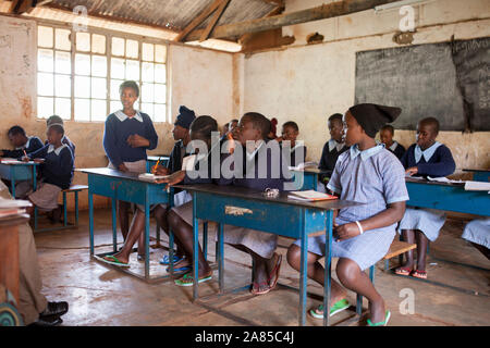 NAIROBI, KENYA-SEPTEMBER 10, 2014: Unidentified girls study in a simple classroom near Nairobi, Kenya. Stock Photo