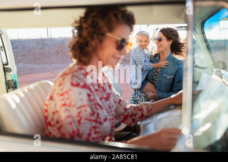 Multi-generation women with map in van Stock Photo