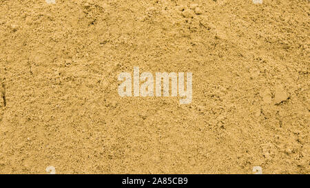 Yellow sand, backdrop texture. Textured sand surface, top view, fine yellow beach sand in a sandbox Stock Photo