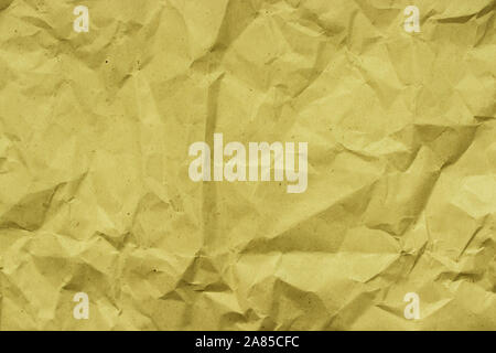 Kraft paper for packaging products and goods. Rough crumpled brown paper, backdrop texture. Yellow beige crumpled texture with creases Stock Photo