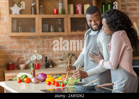 Thankful african lady hugging her husband, cooking together Stock Photo ...