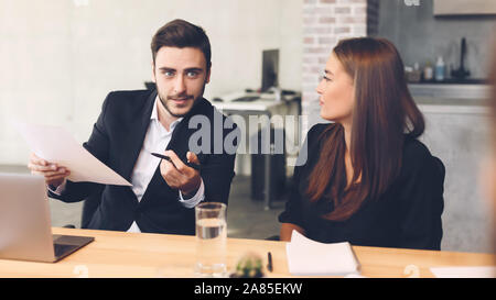 Business colleagues discussing business matters with documents Stock Photo