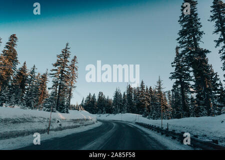 A road on a winter morning as seen through the windshield. Stock Photo