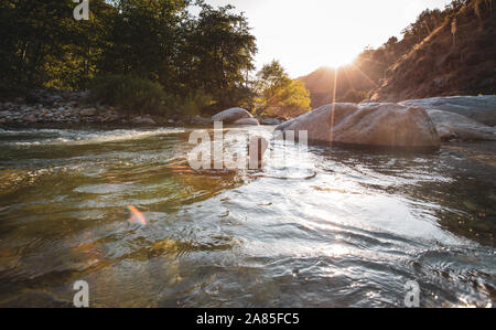 Man relaxing in the Middle Fork Kaweah River Stock Photo