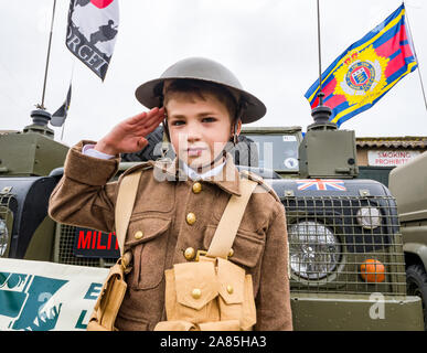 National airshow, East Fortune, East Lothian, Scotland, UK. Harrison aged 8 years in World War I soldier's army uniform makes a salute Stock Photo