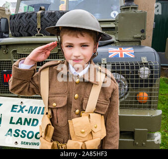 National airshow, East Fortune, East Lothian, Scotland, UK. Harrison aged 8 years in World War I soldier's army uniform makes a salute Stock Photo