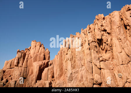 The Rocce rosse / Porphyry Red Rocks Beach formation on the Sardinia coast at Arbatax, Ogliastra coast in Tortolì, Sardinia, in Italy Stock Photo