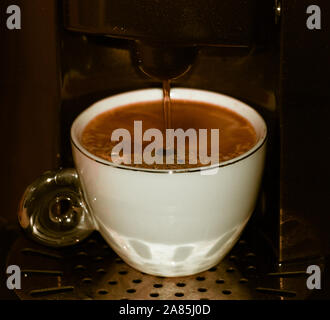 pouring coffee from the machine Stock Photo