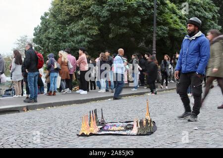 african origin man selling souvenir eiffel towers in paris france Stock Photo