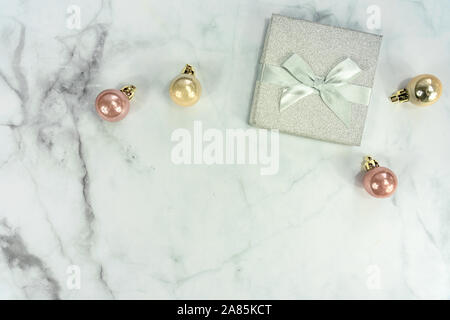 Christmas frame background on marble with silver decoration ornaments and gift box Stock Photo