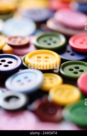 Large Group Of Colorful Plastic Sewing Buttons On a Table, Randomly Arranged With Narrow Focus Stock Photo