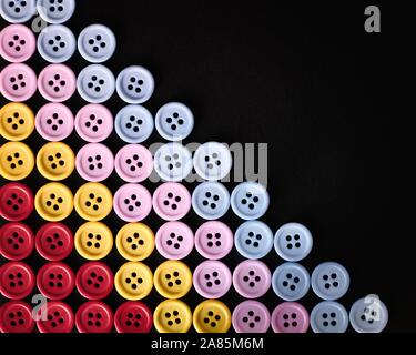 Large Group Of Colorful Plastic Sewing Buttons On Black Background, With Copy Space For Text Stock Photo