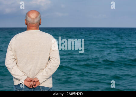 Senior man looking out to sea Stock Photo