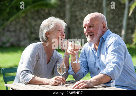 Senior couple enjoying a glass of white wine Stock Photo