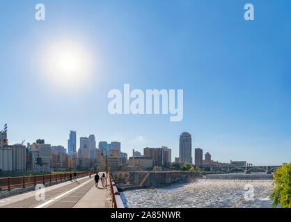 Minneapolis, MN. The downtown skyline from the Stone Arch Bridge with St Anthony Falls to the right, Mississippi River, Minneapolis, Minnesota, USA Stock Photo