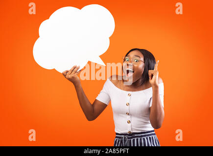 Afro Girl Holding Speech Bubble Pointing Finger Up, Studio, Mockup Stock Photo