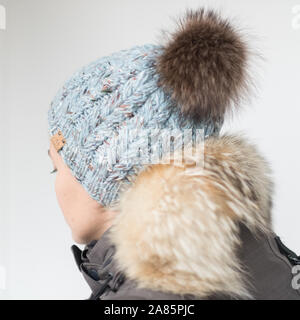 Pretty young woman wearing a hat with pom Stock Photo