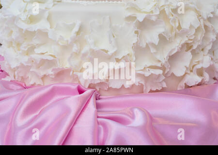 Wedding cake decoration with pink silk fabric Stock Photo