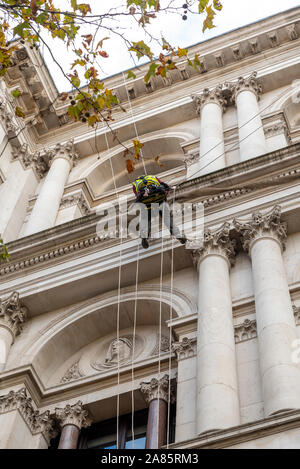 Rope access abseiling. Male working at height on The Foreign and Commonwealth Office in Whitehall, London, UK  Government departments Stock Photo