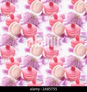 Macaroni with raspberries, marshmallows on a background of beautiful flowers of clematis. Dessert Close-up. Seamless texture. Stock Photo