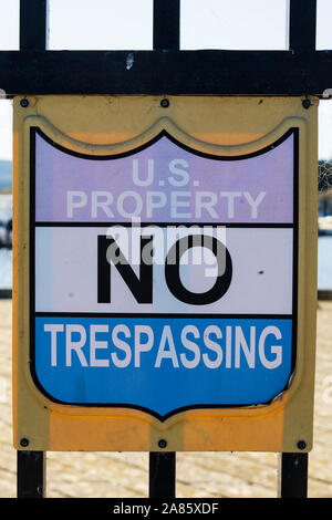 “US Property, No trespassing” sign on the railings at the Coast Guard pier, Monterey, California, United States of America. Stock Photo