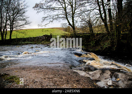 The River Dee flows through Cowgill, Dentdale, North Yorkshire,UK, after a heavy downpour of rain Stock Photo