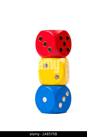Three colorful dice in primary colors stacked on each other isolated on white background showing numbers one, two, three. Red, Yellow, Blue. Tower of Stock Photo