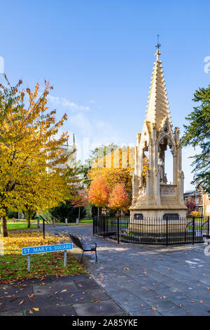St Mary de Lode church and Bishop Hoopers Monument in autumn in St Marys Square, Gloucester UK