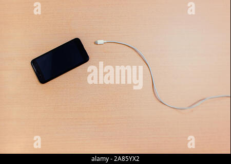 USB cable about to enter the smartphone Stock Photo
