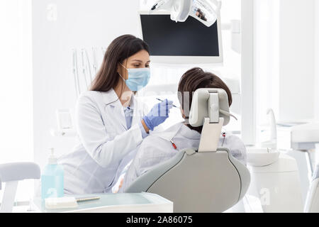 Dentist making check up for patient in dental clinic Stock Photo
